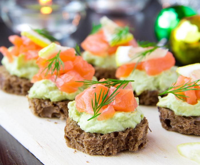 Smoked salmon and avocado canapés on rye bread