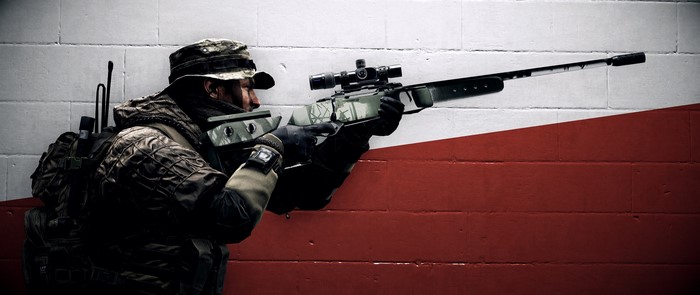 Soldier with sniper rifle in front of a red and white wall