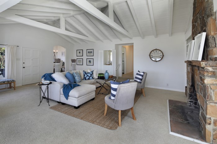 Living room with sofa, chairs, and fireplace