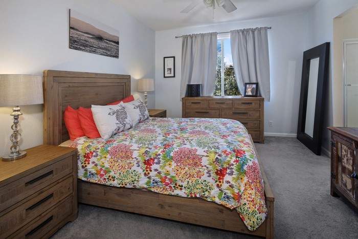 Bedroom with a bed, dresser, and mirror