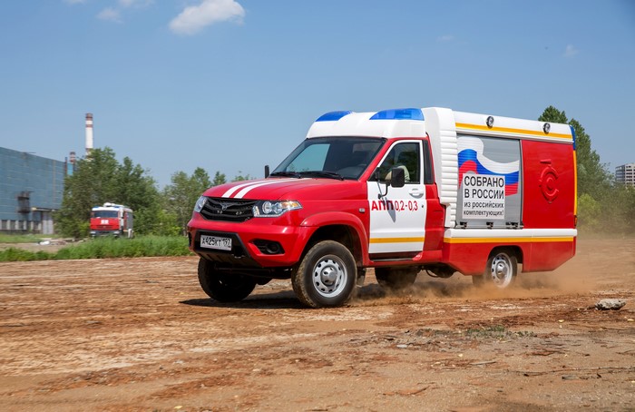 Red Russian fire truck driving on dirt road