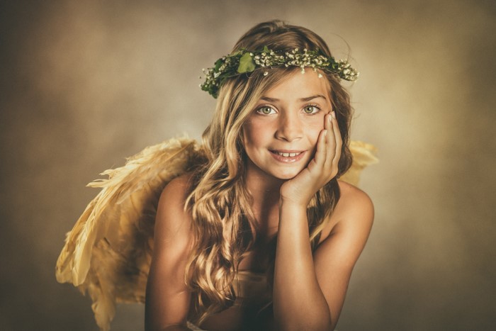 Girl with angel wings and flower wreath