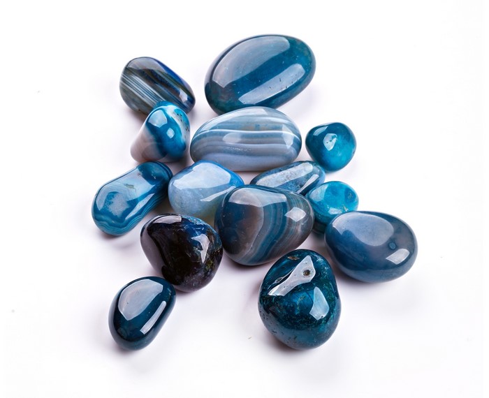 Blue and white striped agate stones on a white background