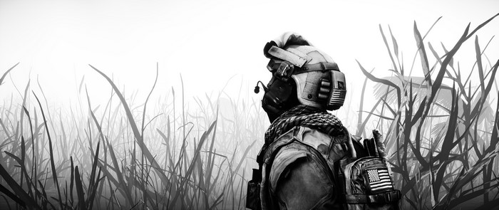 Soldier in military helmet in grass