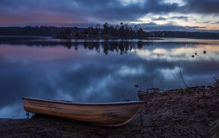 Boat on a calm lake at dusk in Sweden