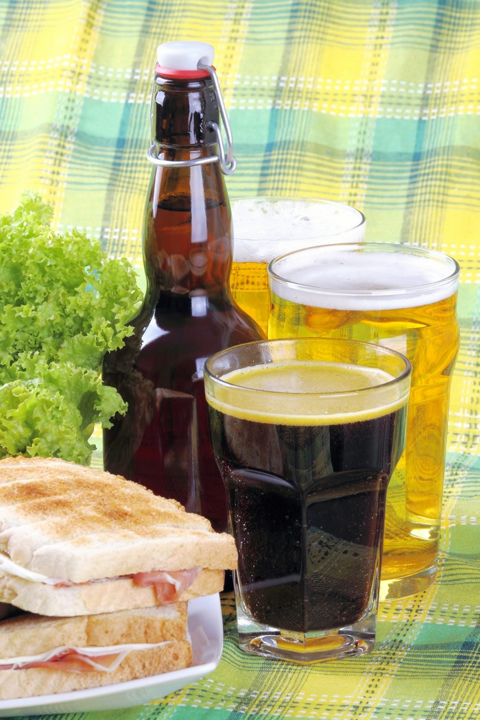 Bottle of beer with sandwiches and lettuce
