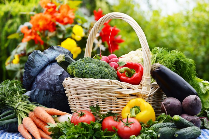 Vegetables in a wicker basket with flowers