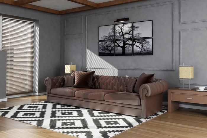 Living room with brown sofa and geometric rug