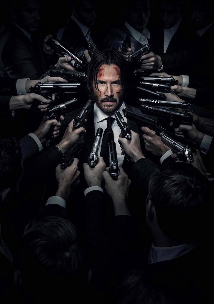 Keanu Reeves as John Wick surrounded by guns