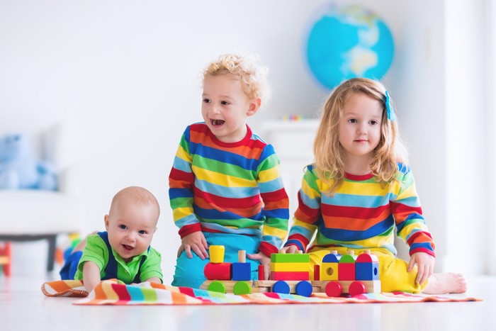Three Children Playing with Toy Train