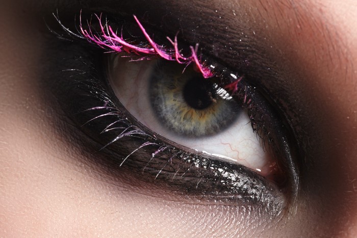 Close-up of eye with pink and black mascara
