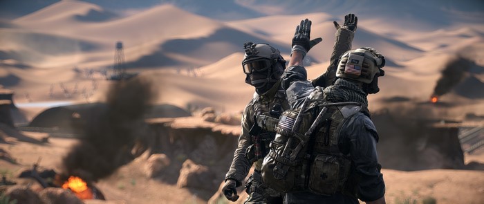 Two soldiers giving a high five in a desert
