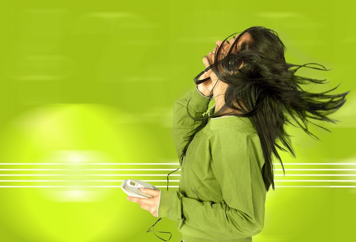 Brunette girl with headphones listening to music