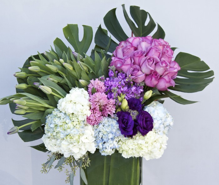 Purple and White Flower Arrangement with Green Leaves
