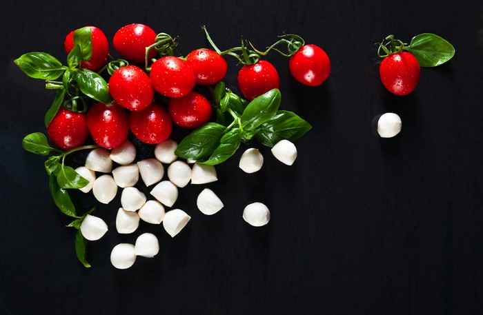 Tomatoes and Mozzarella Cheese on Black Background