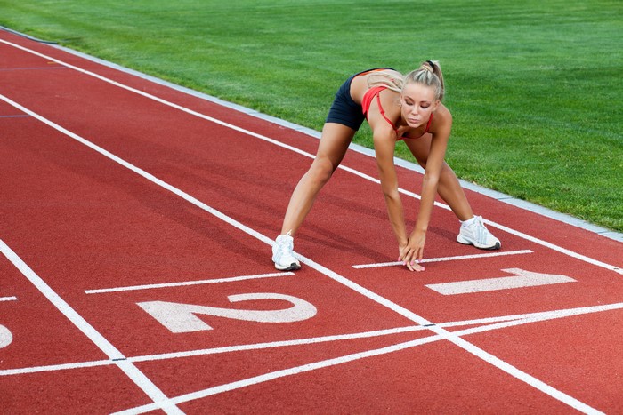 Woman stretching on a running track