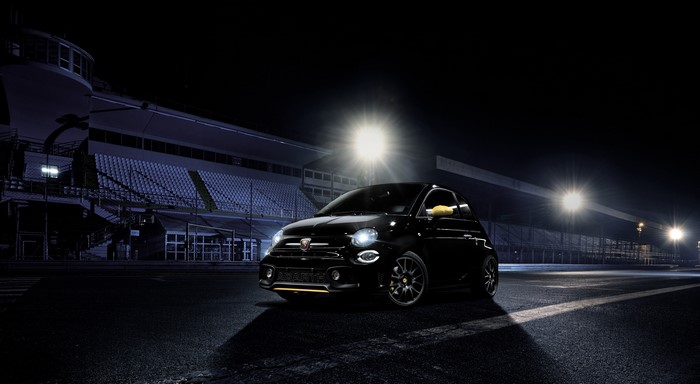 Black Abarth 500 at night on a race track