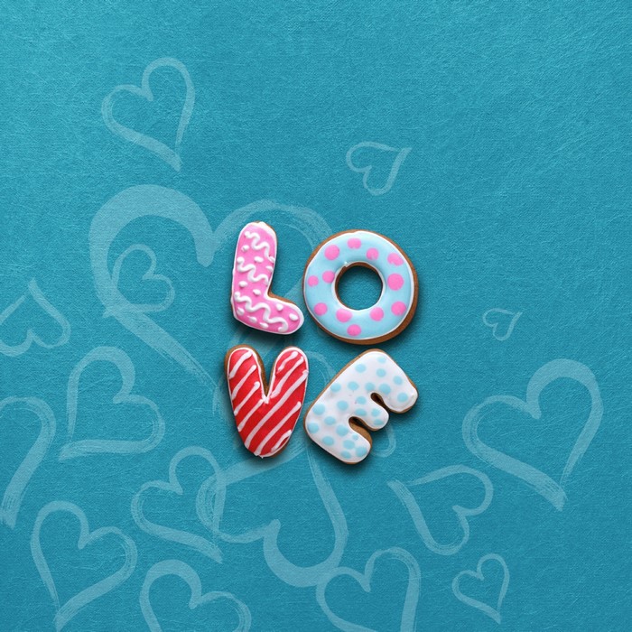 Love cookies with icing on a blue background with hearts
