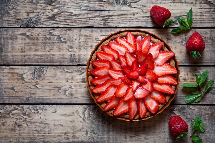 Strawberry tart on wooden planks