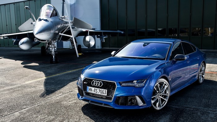 Blue Audi RS 7 Sportback next to a fighter jet