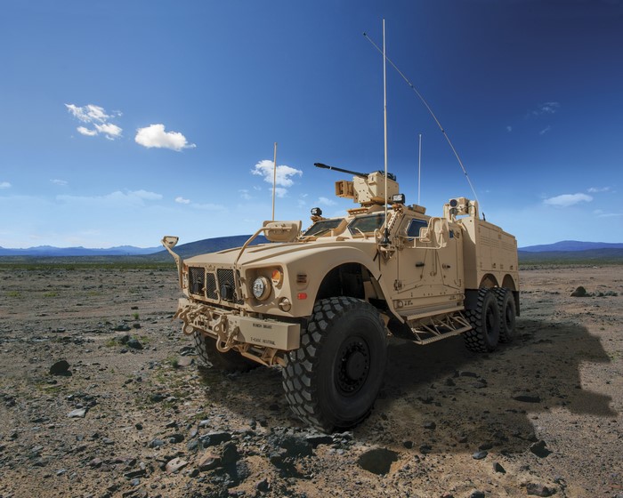 Military vehicle with machine gun in desert