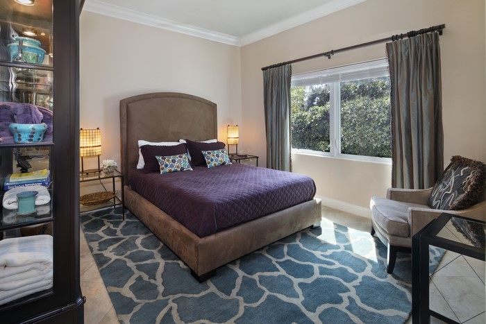 Bedroom with Purple Bedding and Blue Carpet