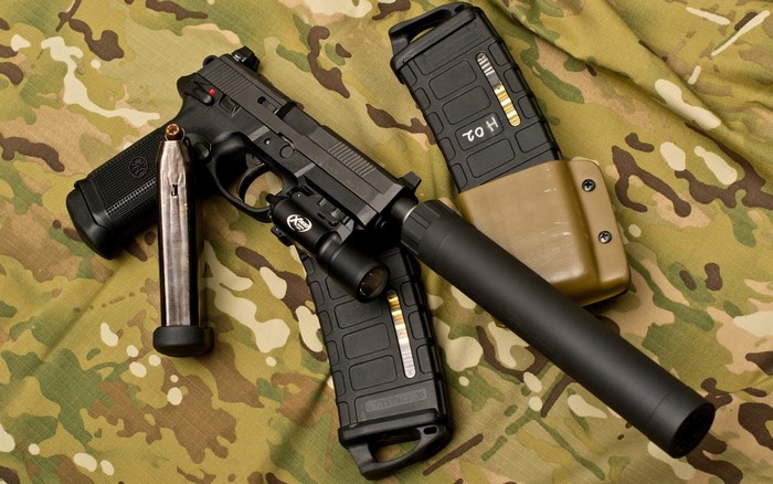 FN pistol with suppressor and magazines