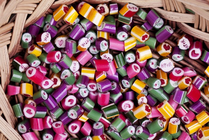Colorful candies with hearts and text in a basket