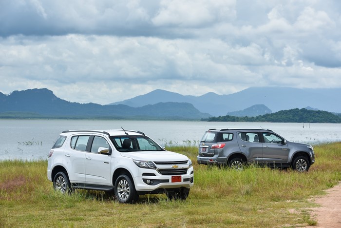 Two Chevrolet Trailblazer SUVs by a Lake