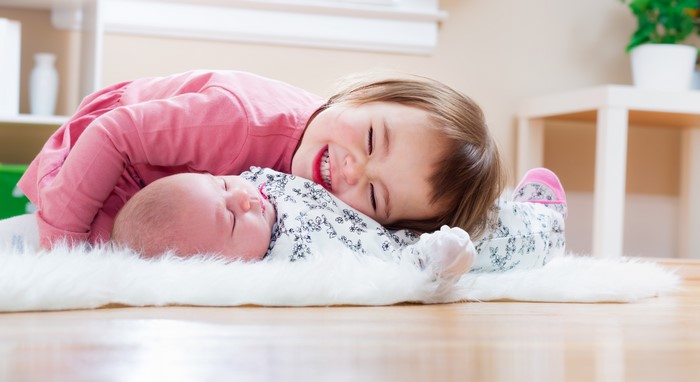 Two little girls, one infant, smiling