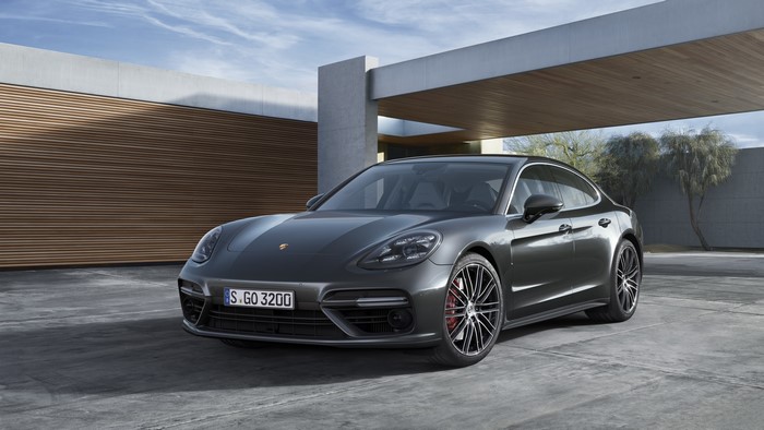 Grey Porsche Panamera parked outside modern building