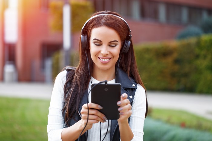 Woman with headphones using a tablet
