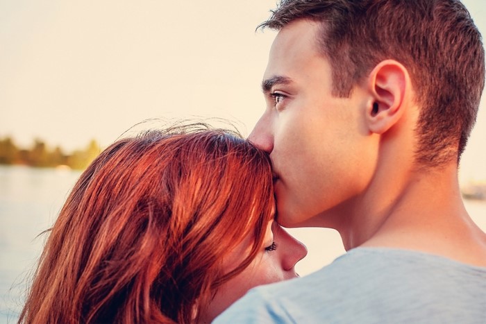 Couple in love, man kissing woman's forehead