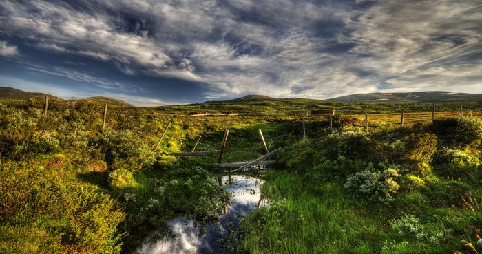 Einunndalen, Norway: Stream and Rolling Hills Under Cloudy Sky