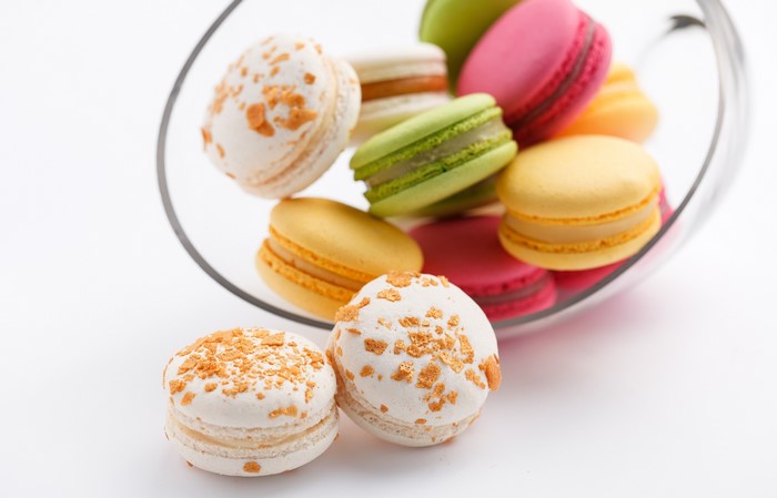 Colorful macarons in a glass bowl