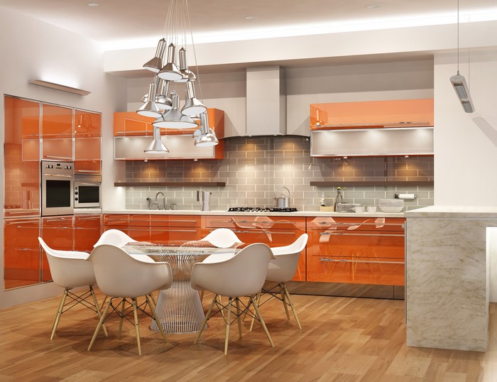 Modern orange kitchen with dining table and chairs