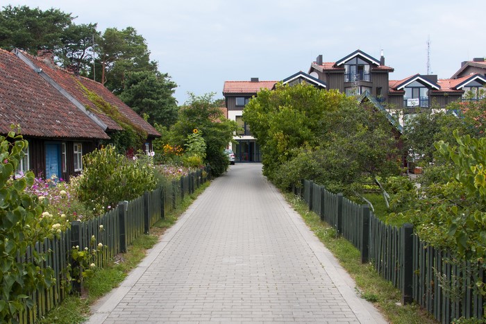 Street with houses and fences in Nida, Lithuania