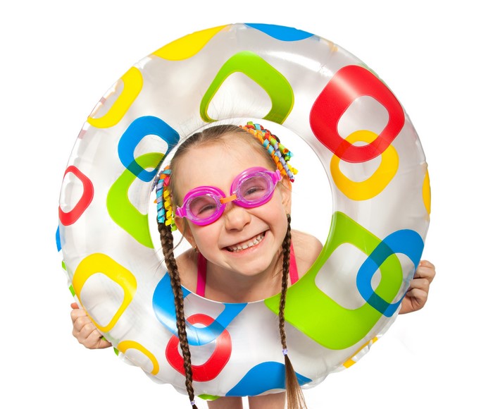 Girl with swim ring and goggles on white background
