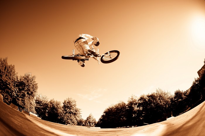 BMX rider performing a trick in the air