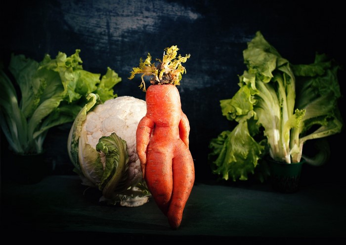 Carrot shaped like a woman with cauliflower and lettuce