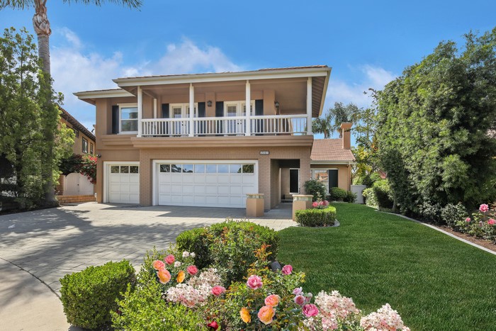 Luxury house with roses and manicured lawn