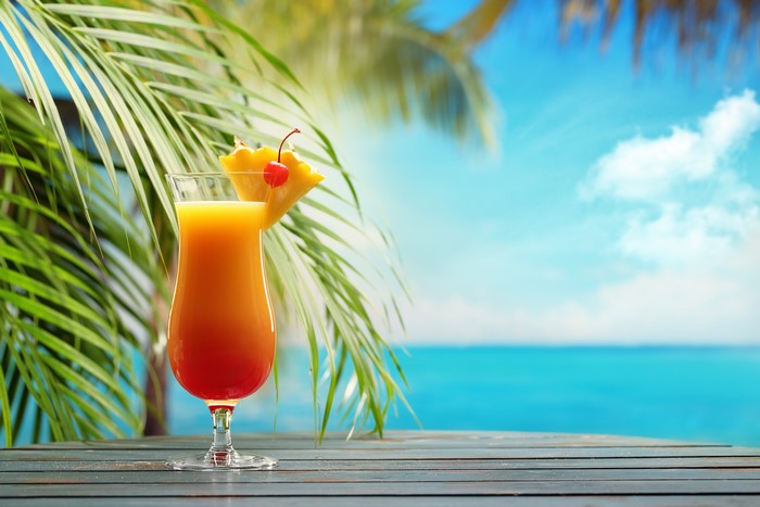 Cocktail with pineapple and cherry on a table