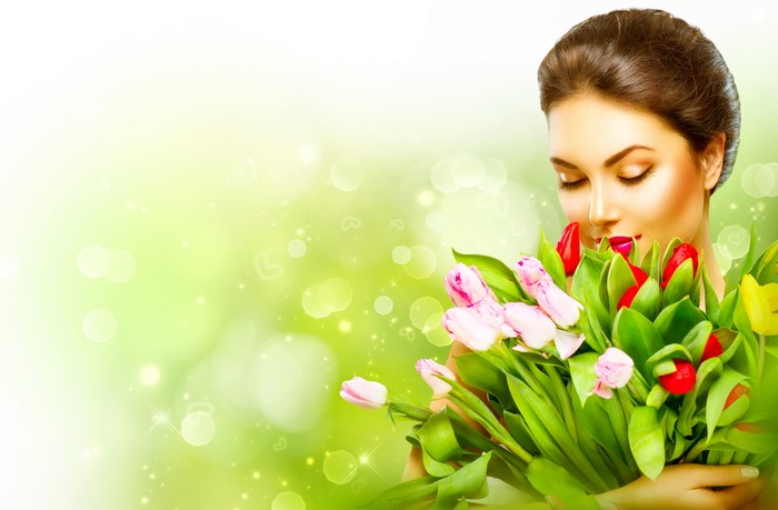 Woman smelling a bouquet of tulips