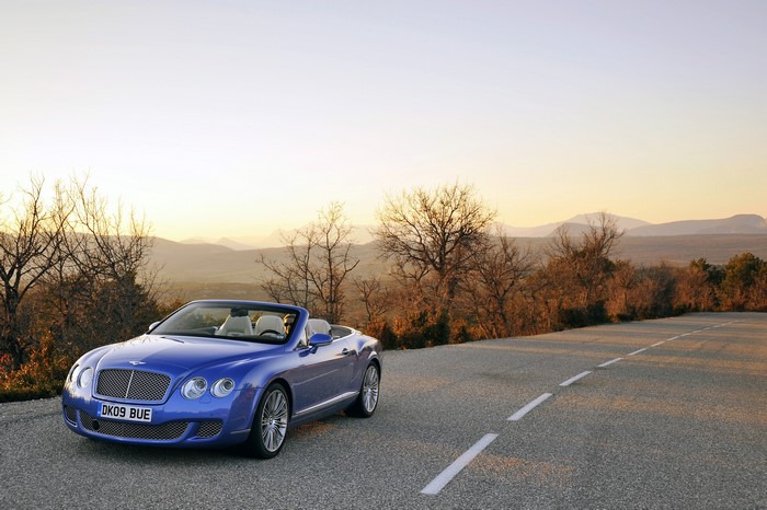 Blue Bentley Continental GTC Speed convertible on a road