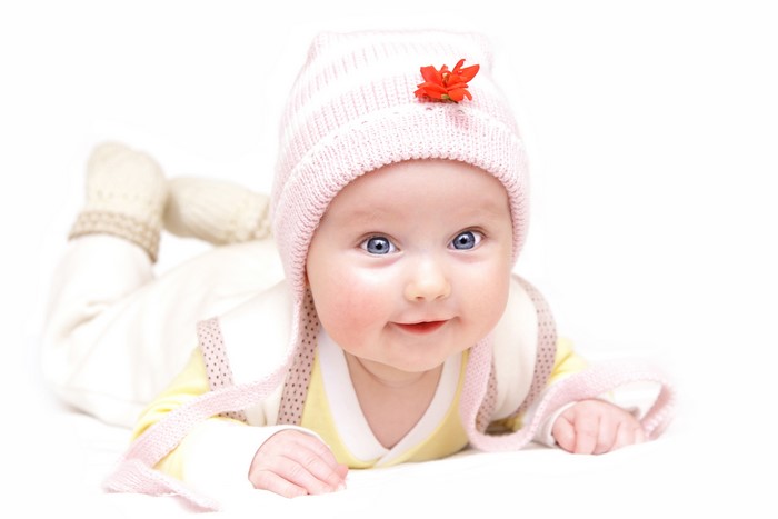 Baby in a pink winter hat with a flower