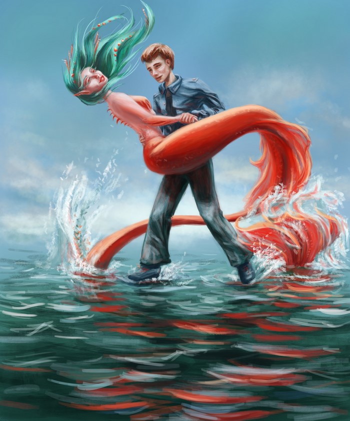 Man holding a mermaid with a red tail in the water