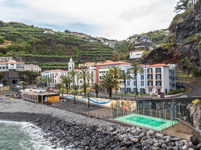 Ponta do Sol, Madeira, Portugal coast with buildings and sports court
