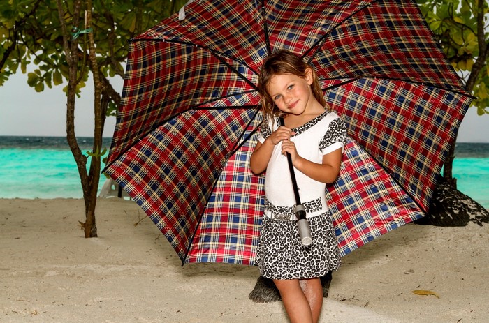 Girl with umbrella on a beach