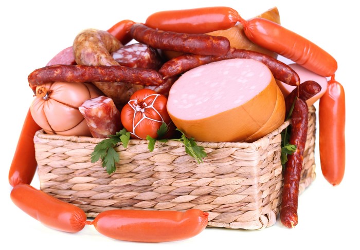 Assortment of sausages and meat products in a wicker basket