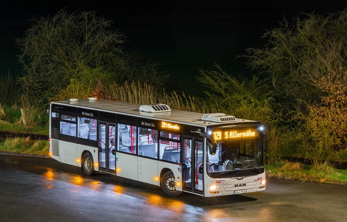MAN bus with illuminated interior at night